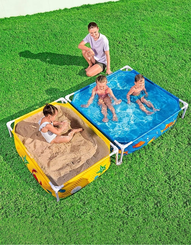 Kids playing in Bestway 561CF frame pool and sandpit combo, one side filled with water and the other with sand, supervised by an adult